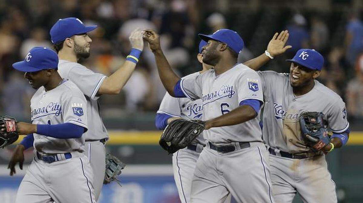 
The Royals’ Jarrod Dyson (from left) Eric Hosmer, Lorenzo Cain and Alcides Escobar celebrated their 11-4 over Detroit on Tuesday night that put Kansas City in first place in the AL Central.
