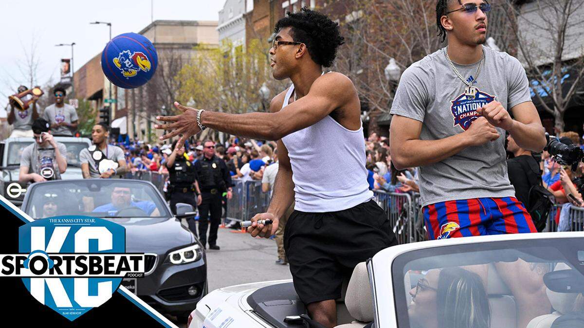 Remy Martin tosses an autographed ball to a fan as he and teammate Jalen Wilson ride in the Kansas Jayhawks NCAA Championship parade Sunday in Lawrence.
