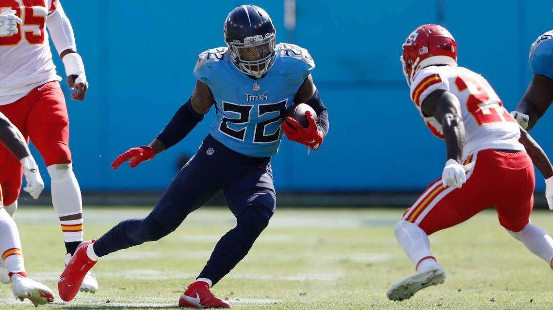 Chiefs cornerback Rashad Fenton, right, confronts hard-charging Titans running back Derrick Henry during Sunday’s game in Nashville.