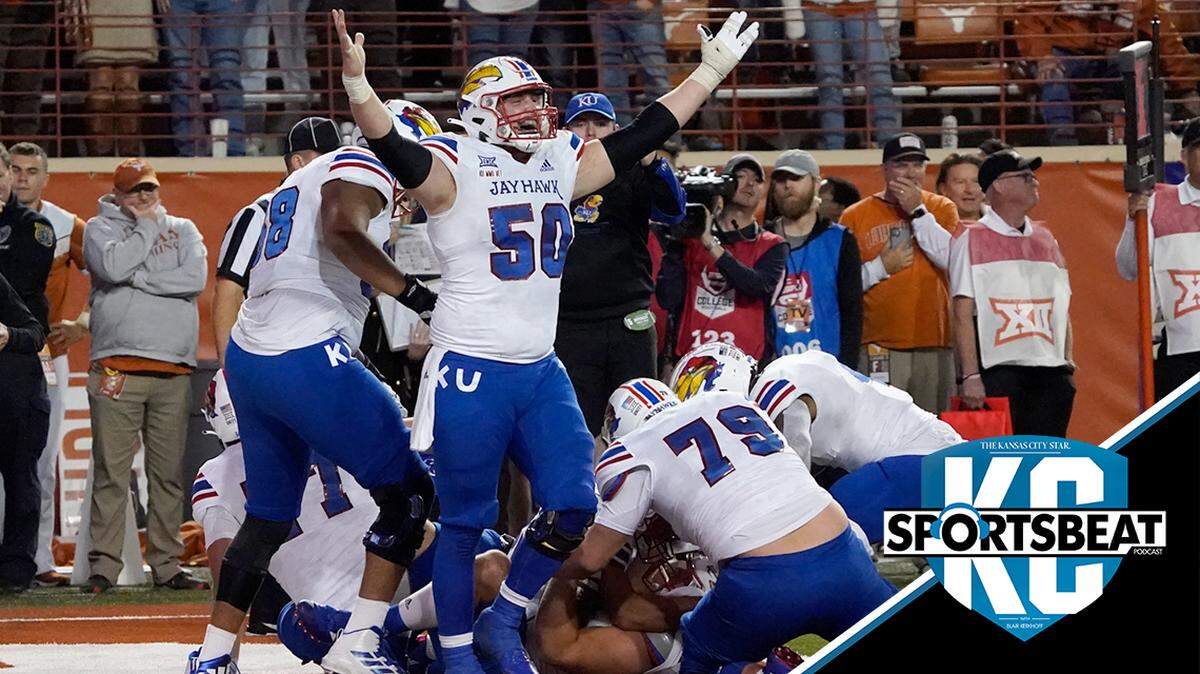 Kansas players including Mike Novitsky (50) celebrate their 57-56 win over Texas in overtime of an NCAA college football game in Austin, Texas, Saturday, Nov. 13, 2021. (AP Photo/Chuck Burton)
