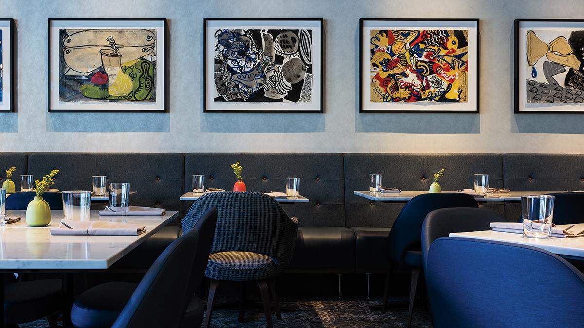 Lester Goldman’s bright abstracts adorn a wall of The Restaurant at 1900 in this file photo.