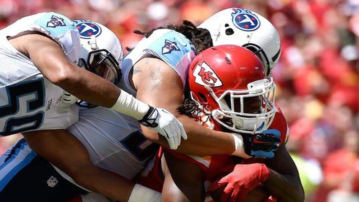 
Kansas City Chiefs running back Jamaal Charles (25) picked up 3 yards before being stopped by Tennessee Titans outside linebacker Zaviar Gooden (50) during the second quarter on Sunday at Arrowhead Stadium in Kansas City, Mo. 
