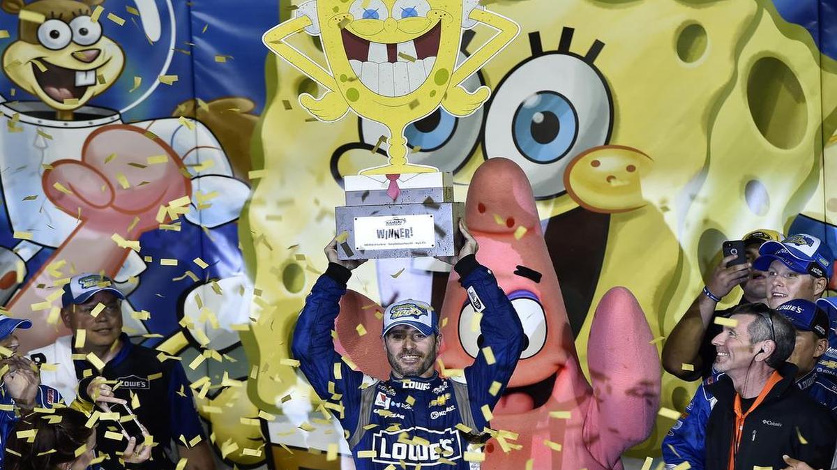 
Jimmie Johnson (48) raises the trophy after winning the Sprint Cup Series SpongeBob SquarePants 400 at the Kansas Speedway Saturday, May 9, 2015.
