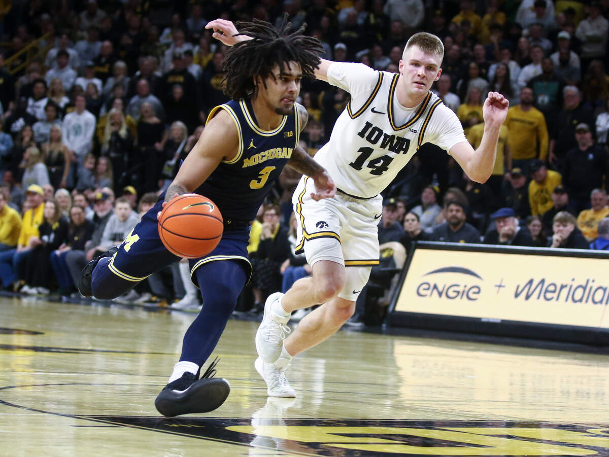 Iowa’s Bennett Stirtz, right, tracks Michigan’s Elliot Cadeau during a game at Carver-Hawkeye Arena in Iowa City, Iowa on March 5, 2026.