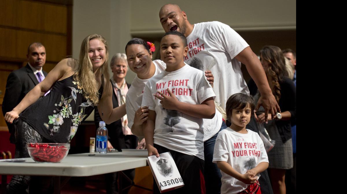 
Mixed-martial-arts fighter Ronda Rousey (left) posed with Junior Siavii (top), his wife, Rezetta Siavii and family members, Sao Siavii, 10, and Michael Siavii, 4, during Rousey’s book signing on Thursday evening, May 28, 2015, at Unity Temple on the Plaza.
