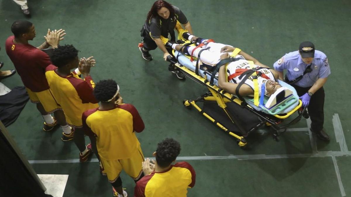 Wichita State’s Anton Grady was carted from the arena as players from the Southern California applaud during the AdvoCare Invitational at HP Field House in Orlando, Fla., on Friday.