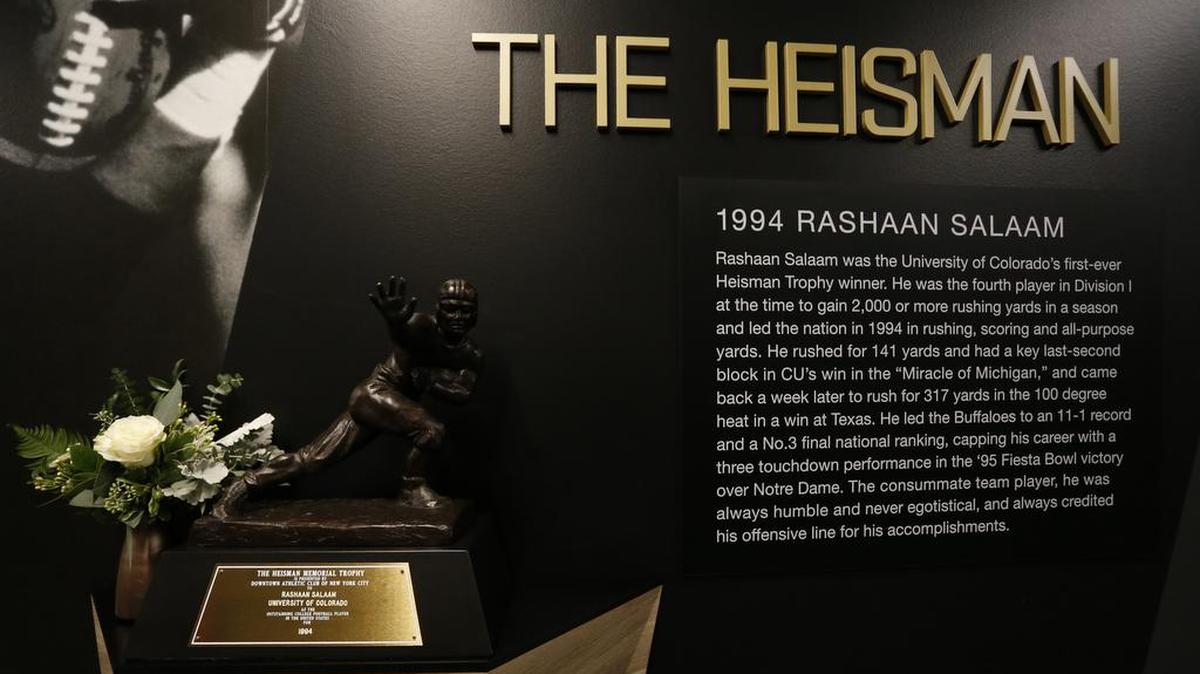 Inside the Champions Center at the University of Colorado, the 1994 Heisman Trophy for former Colorado running back Rashaan Salaam is adorned with a memorial flower Tuesday, Dec. 6, 2016, after Salaam’s body was found Monday evening at a park, in Boulder, Colo.