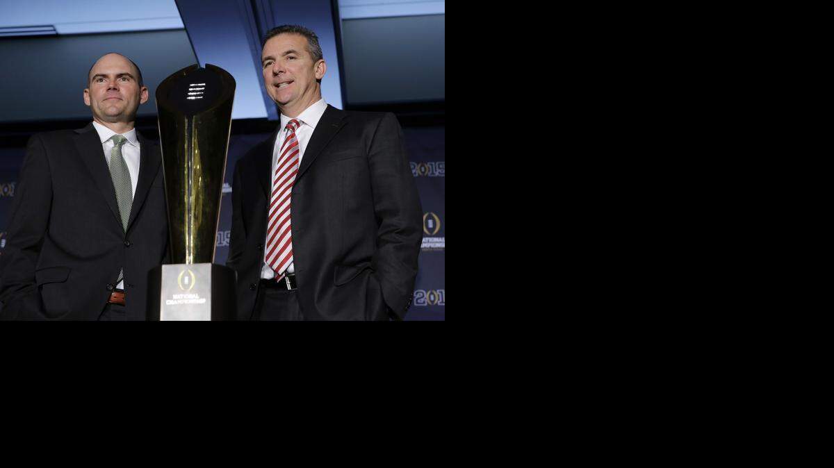 
Oregon head coach Mark Helfrich (left) and Ohio State coach Urban Meyer are shooting for the national championship trophy tonight.


