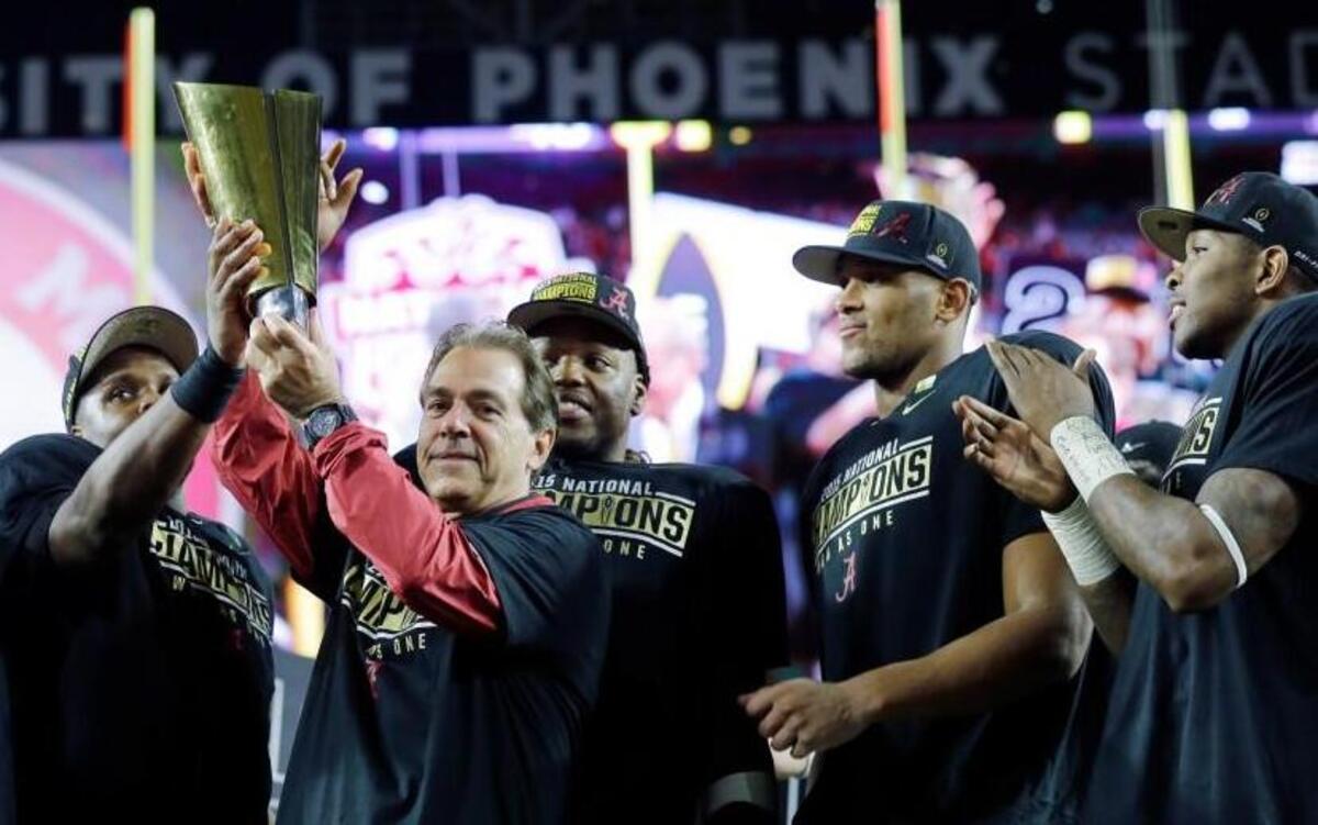 Alabama coach Nick Saban and players celebrate with the College Football Playoff championship trophy Monday in Glendale, Ariz. Alabama beat Clemson 45-40.