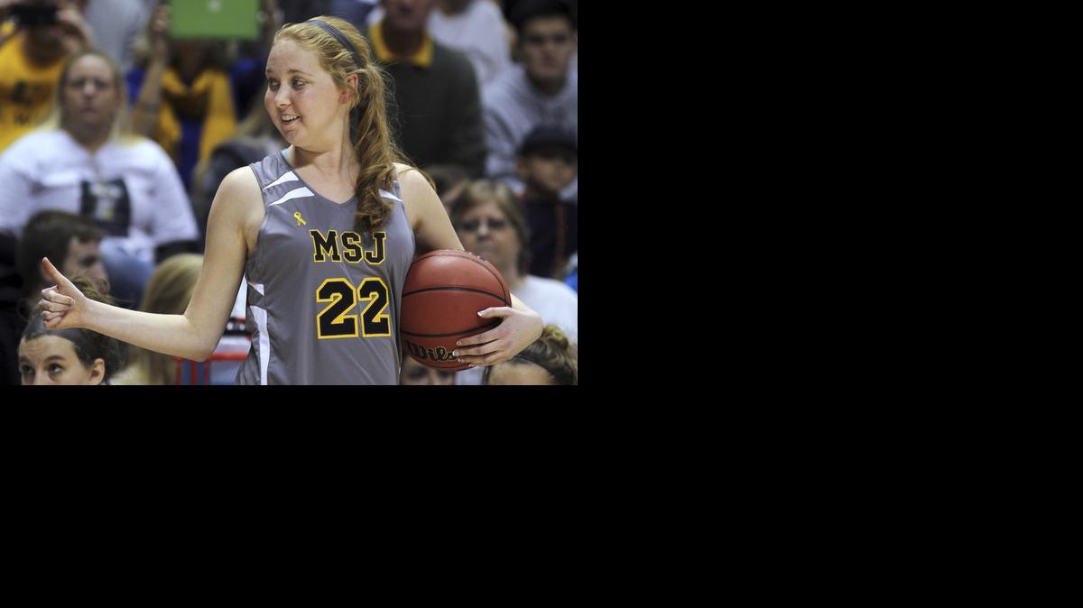 
Mount St. Joseph's Lauren Hill gives a thumbs-up last fall as she holds the game ball during her first NCAA college basketball game

