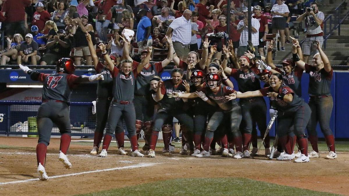 Oklahoma’s Shay Knighten was greeted at the plate after hitting a three-run home run in the 17th inning of the first game of the best-of-three Women’s College World Series against Florida. Oklahoma won 7-5 in 17 innings.