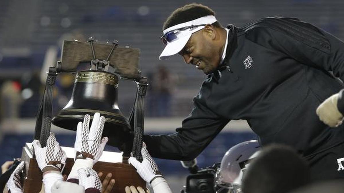 
Texas A&M head coach Kevin Sumlin rings the Liberty Bell trophy after beating West Virginia in the Liberty Bowl NCAA college football game Monday
