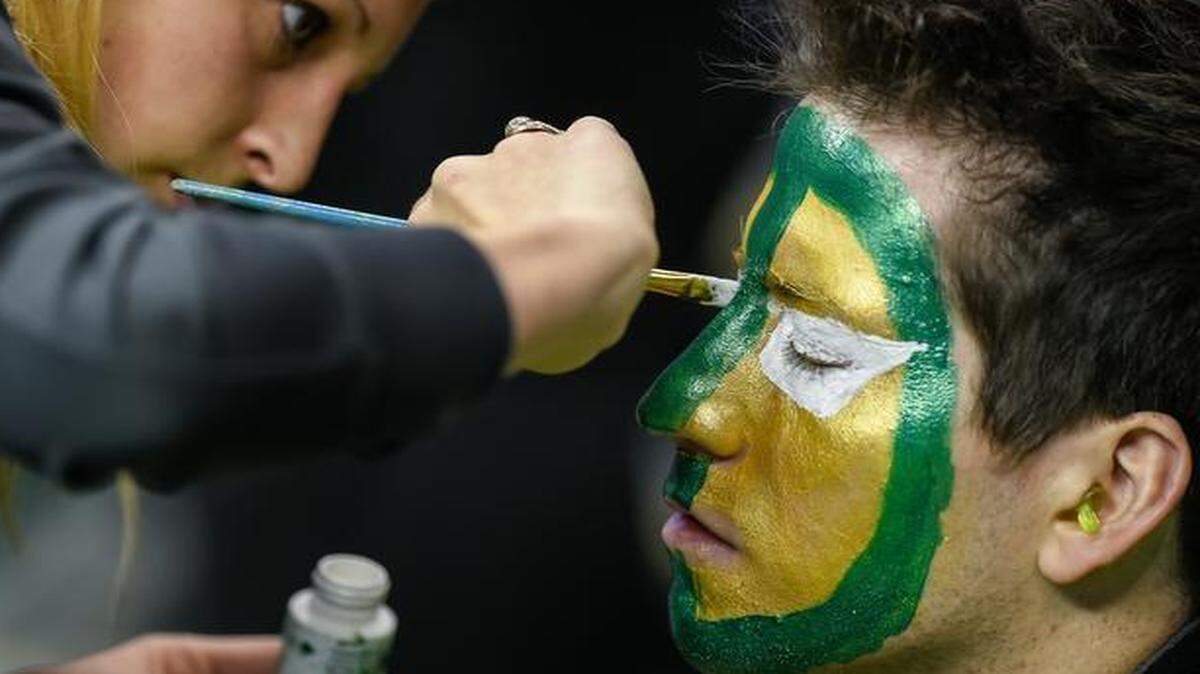 
Colby Kirk, an alto saxophone player with the Baylor Bears band, had his face painted by Vivian Morvant (left) prior to game action against the West Virginia Mountaineers Thursday morning at the Big 12 Tournament at Sprint Center.
