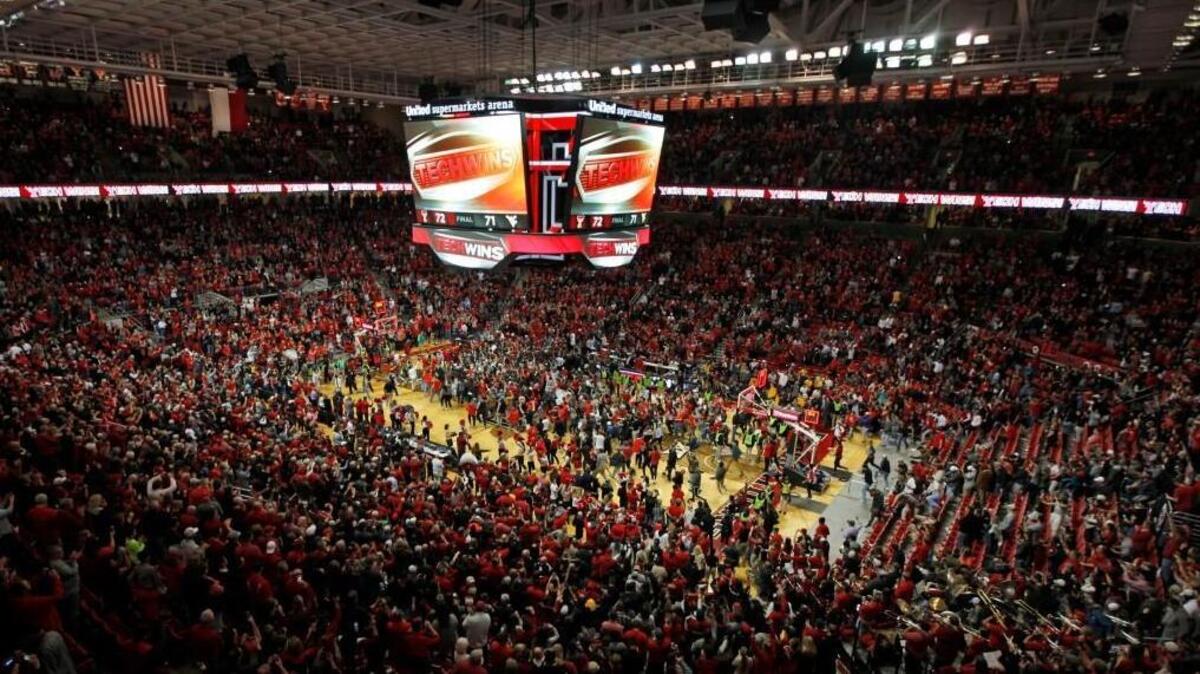 Texas Tech fans celebrate on the court after the Raiders beat West Virginia on Saturday in Lubbock.