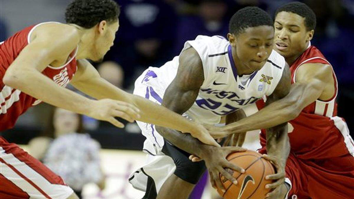 
Kansas State's Nigel Johnson (23) steals the ball away from Bradley's Auston Barnes, left, and Anthony Fields, right, during the first half of an NCAA college basketball game Tuesday, Dec. 9, 2014, in Manhattan, Kan. Kansas State won 50-47. (AP Photo/Charlie Riedel)
