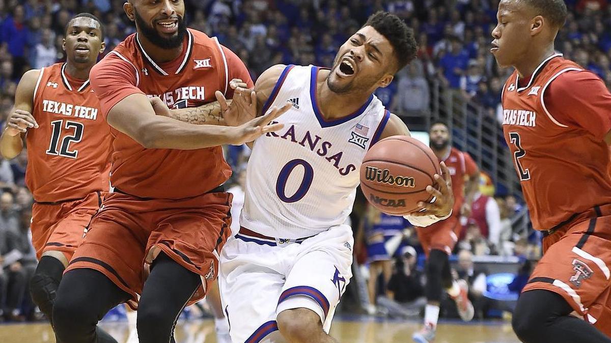 KU's Frank Mason (middle) is fouled by Texas Tech's Anthony Livingston on a drive to the basket during the first half of Saturday night's game at Allen Fieldhouse.