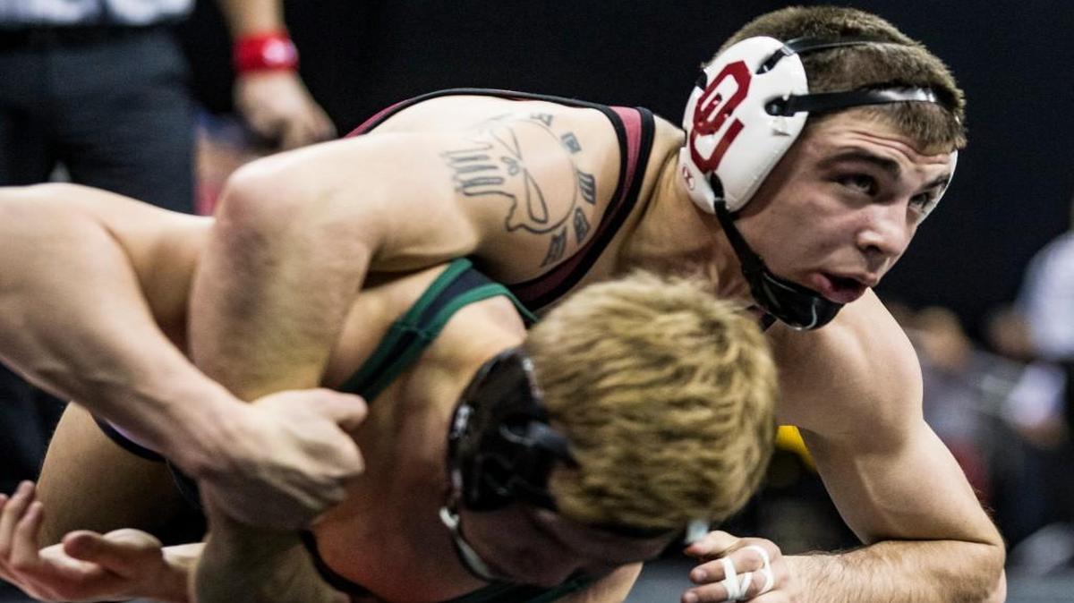 Oklahoma’s Cody Brewer (top) had Iowa State’s Earl Hall against the mat Saturday in their 133-pound semifinal at the Big 12 Championships at the Sprint Center.