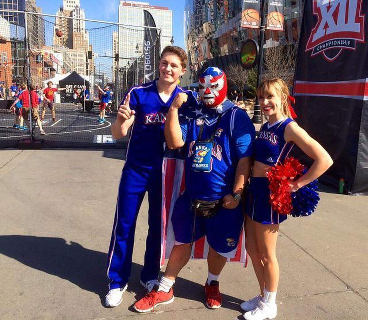 Joseph Flores of Kansas City posed with two cheerleaders from the KU squad after the pep rally outside the Big 12 Tournament back in 2015.