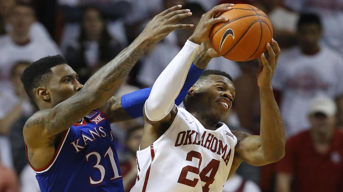 Oklahoma and Buddy Hield (right) will take on Kansas and Jamari Traylor on Monday night in Lawrence as the Nos. 1- and 2-ranked teams in the country.