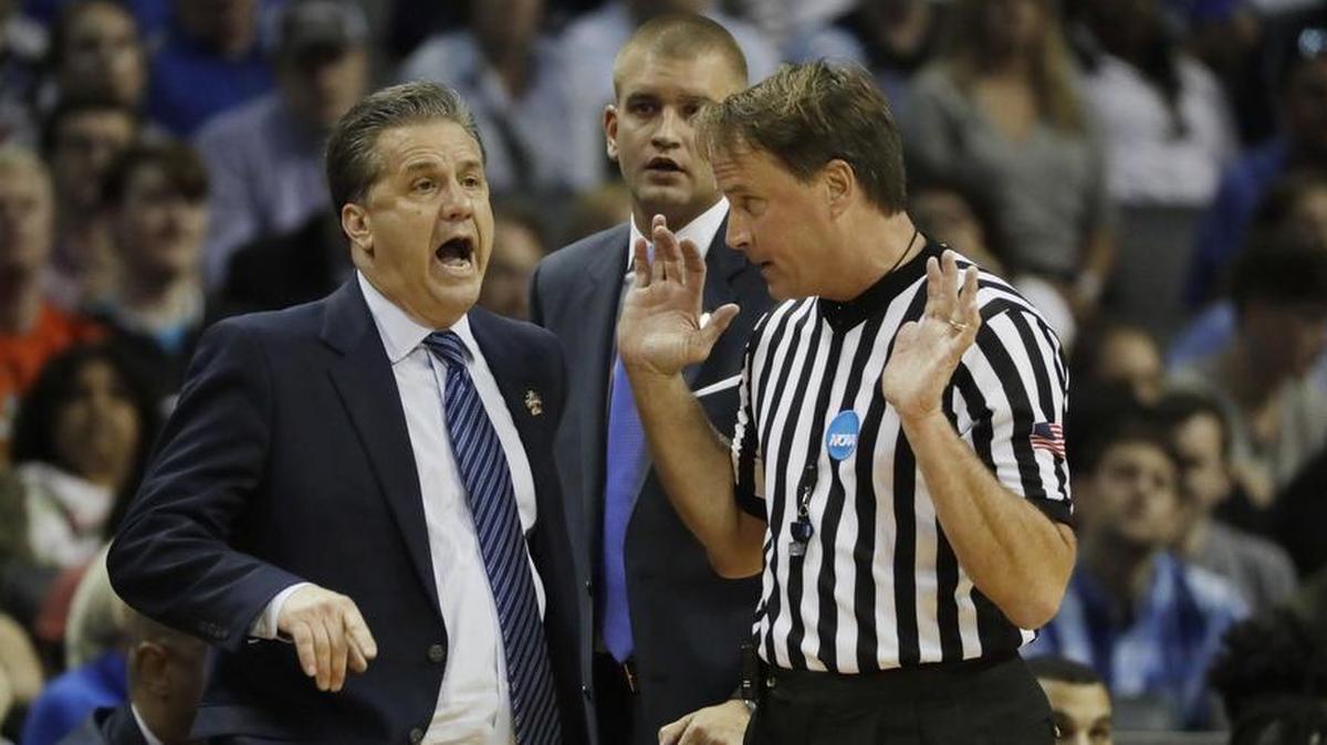 FILE - In this March 26, 2017, file photo, Kentucky head coach John Calipari argues a call with referee John Higgins in the first half of the NCAA South Regional final against North Carolina. Higgins has filed a civil lawsuit Tuesday, Oct. 3, 2017, in federal court against a Kentucky media company after he and family members were harassed following the game, which Kentucky lost.