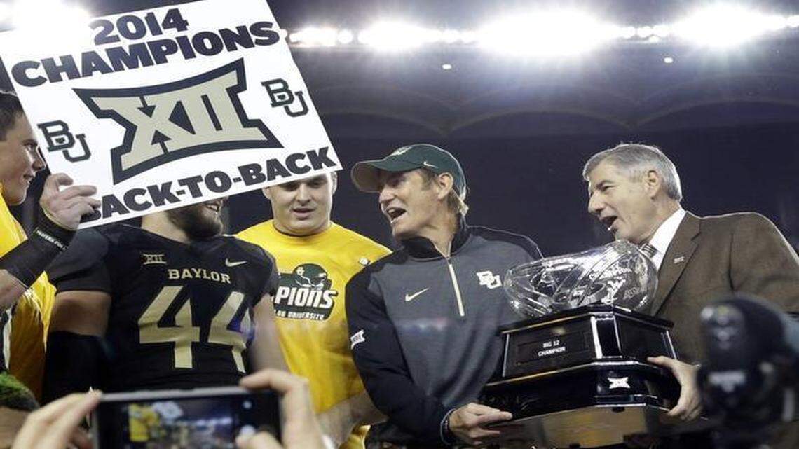 
Big 12 Commissioner Bob Bowlsby, right, presented Baylor football coach Art Briles, center, with the conference trophy on Dec. 6, 2014. Earlier in the day, Bowlsby also presented a trophy to co-champion TCU, which lost to Baylor earlier in the season.
