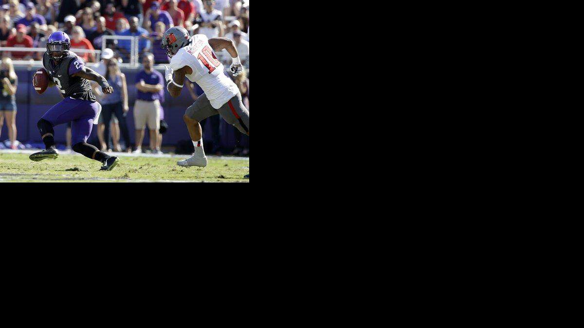
TCU quarterback Trevone Boykin (left) evaded pressure from Texas Tech linebacker Pete Robertson in the first half of last Saturday’s game in Fort Worth, Texas. 
