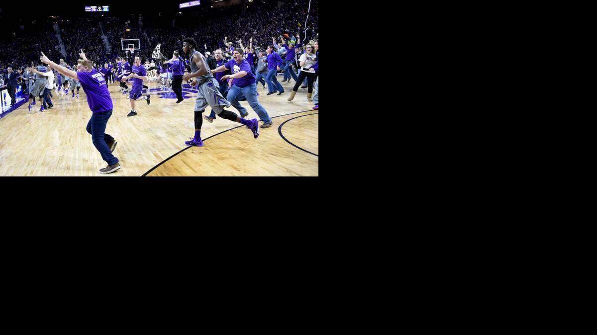 
K-State’s Nino Williams was running off the floor while students were running on it after the Wildcats’ victory Monday night.


