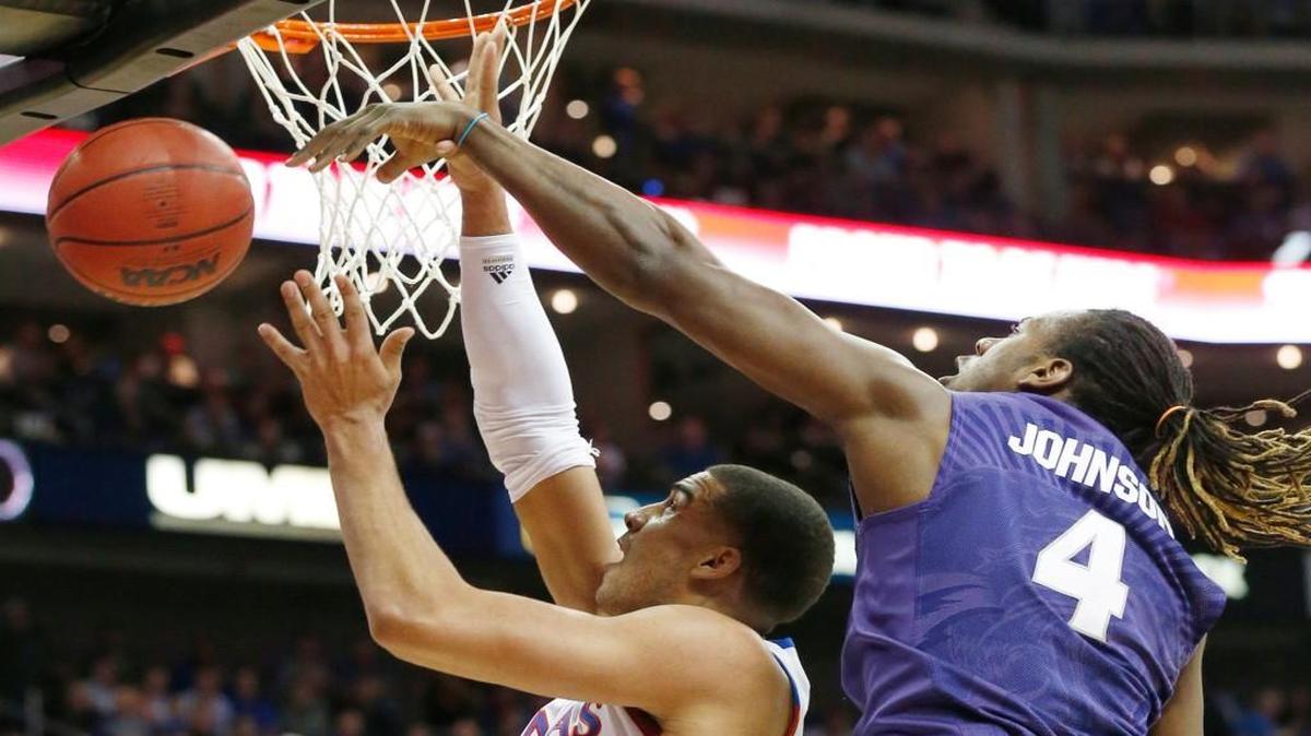 K-State forward D.J. Johnson knocks away a shot by Kansas’ Landen Lucas during last season’s Big 12 Tournament.