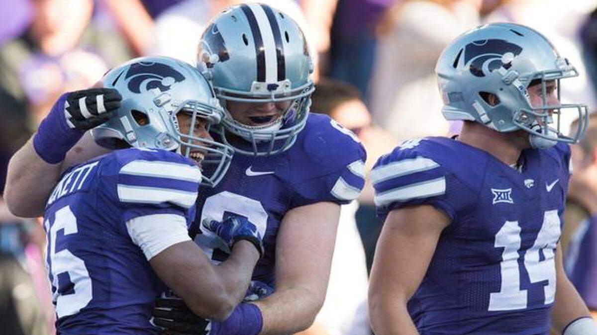 
Kansas State offensive lineman Luke Hayes (68) and wide receiver Curry Sexton (14) congratulated wide receiver Tyler Lockett after Lockett scored a first-quarter touchdown against Kansas in the Sunflower Showdown on Saturday at Bill Snyder Family Stadium in Manhattan.

