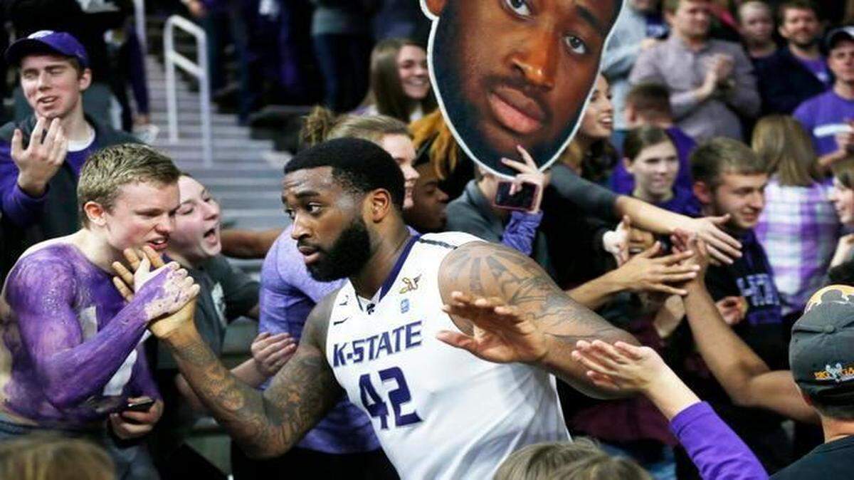 
Kansas State forward Thomas Gipson (42) makes his way around Bramlage Coliseum during an NCAA college basketball game in Manhattan, Kan. on Saturday, Feb. 28, 2015 to celebrate with fans after Kansas State upset #12 Iowa State 70-69. Fans were not allowed on the court after last week's game when Kansas State fans rushed the court. 
