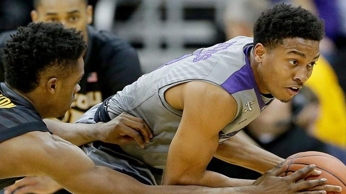 K-State freshman point guard Kamau Stokes (right) has played better since returning to the starting lineup.