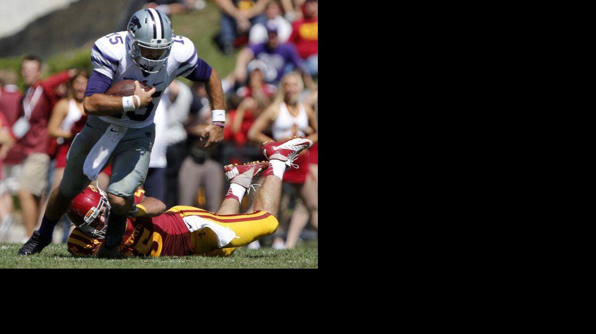 
Kansas State quarterback Jake Waters (15) breaks away from the grasp of Iowa State linebacker Jevohn Miller (55) during the second half of an NCAA college football game Saturday, Sept. 6, 2014, in Ames, Iowa. (AP Photo/Justin Hayworth)
