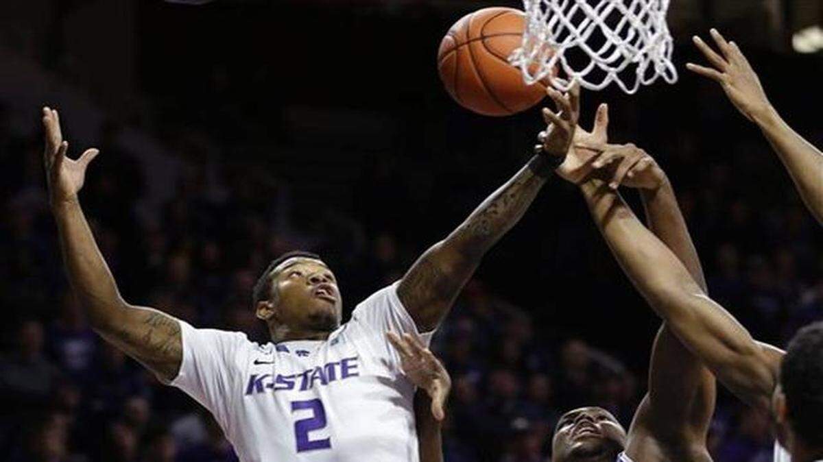 
Kansas State guard Marcus Foster (2) rebounds against TCU forward Devonta Abron, right, during the first half of an NCAA college basketball game in Manhattan, Kan., Wednesday, Jan. 7, 2015. 
