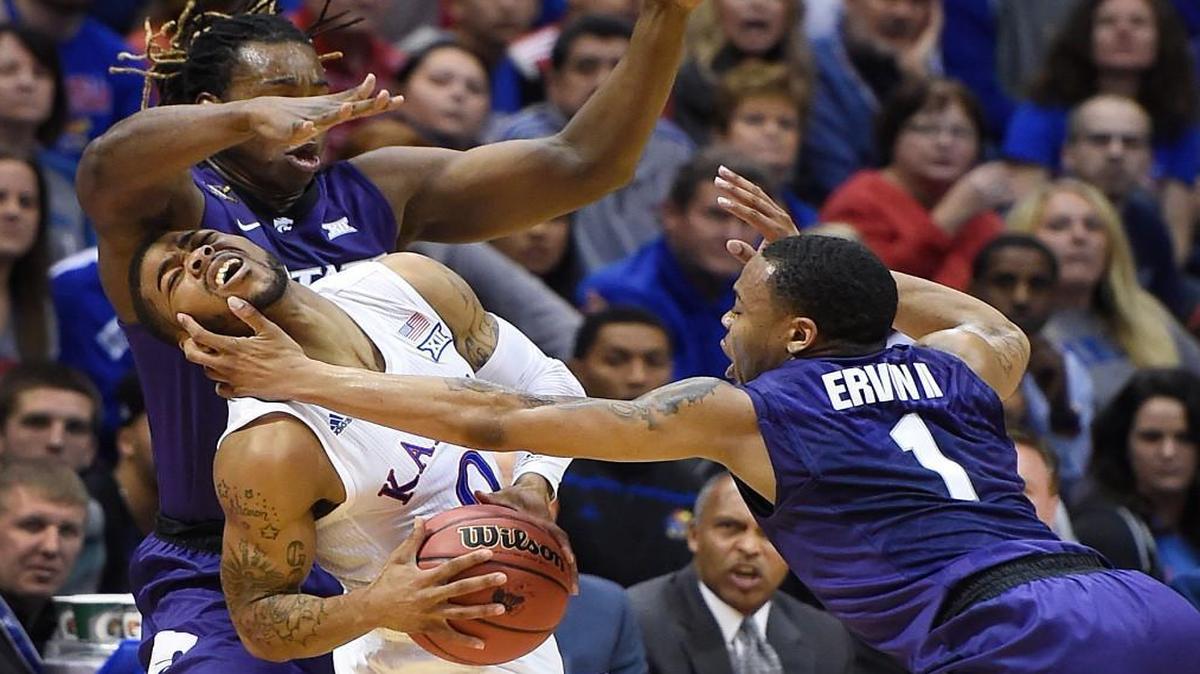 KU’s Frank Mason (middle) found himself in a tight spot after being trapped by Kansas State’s D. J. Johnson (left) and Carble Ervin in the first half of Wednesday night’s Sunflower Showdown game at Allen Fieldhouse.