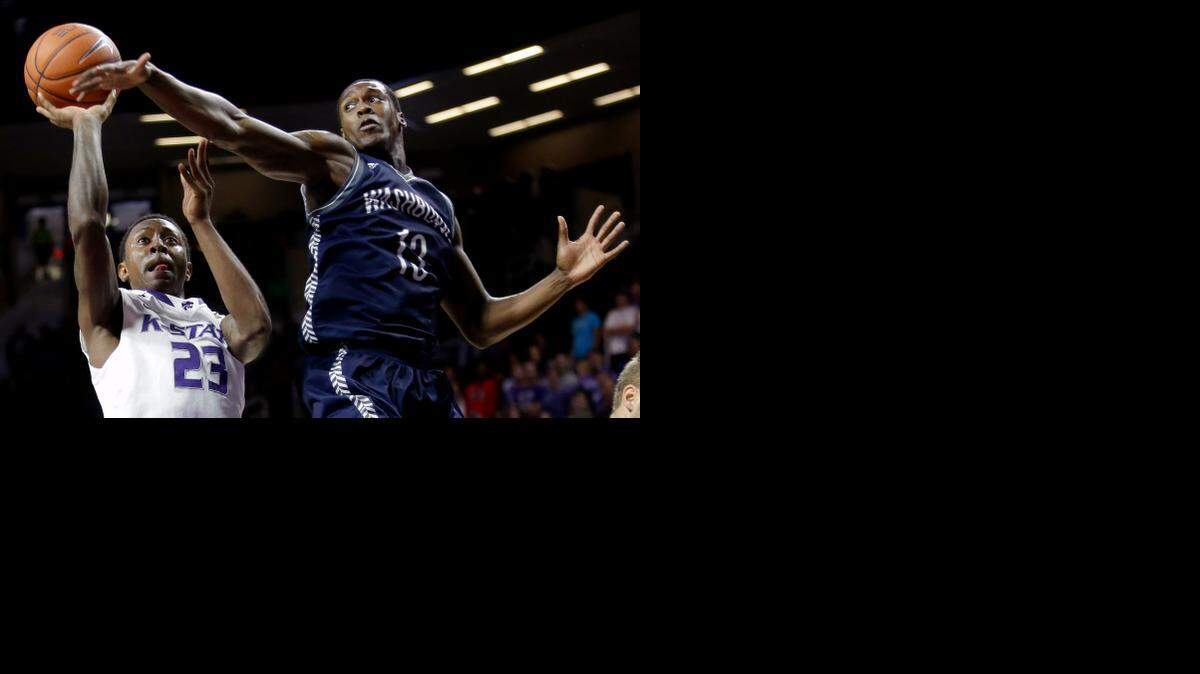 
Kansas State’s Nigel Johnson (23) shot under pressure from Washburn’s Chris Deanes in the first half Sunday in Manhattan, Kan. The Wildcats won the exhibition game 68-56.
