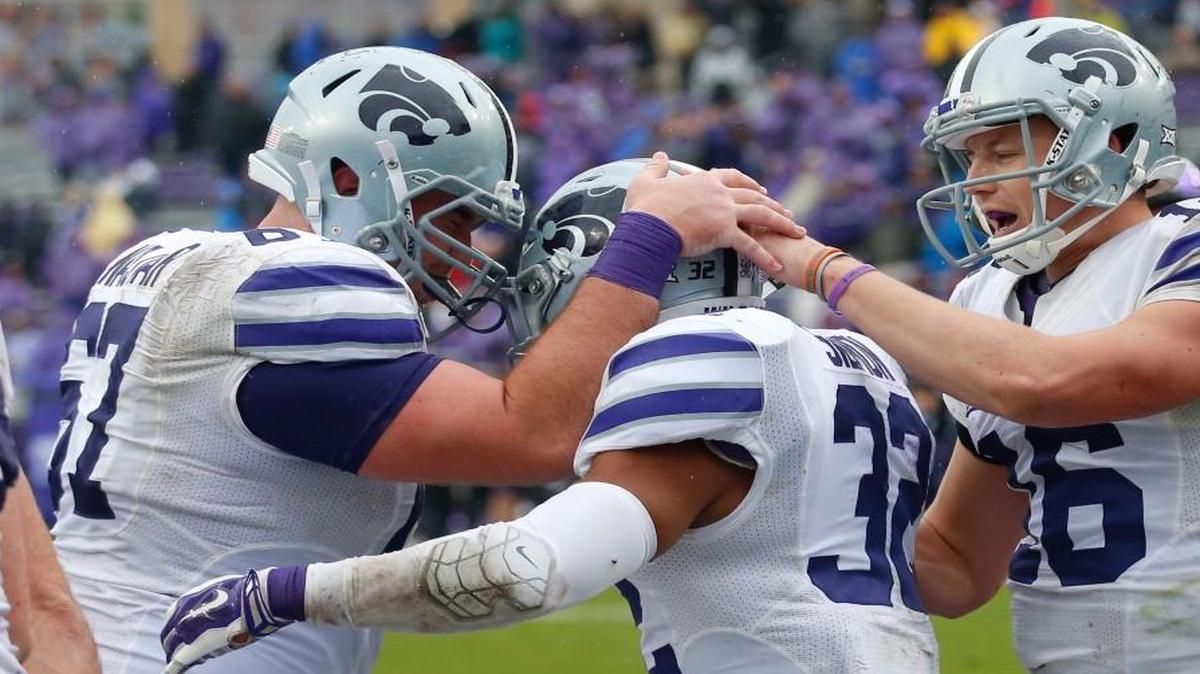 K-State center Reid Najvar, left, and quarterback Jesse Ertz congratulated running back Justin Silmon after a touchdown last season.