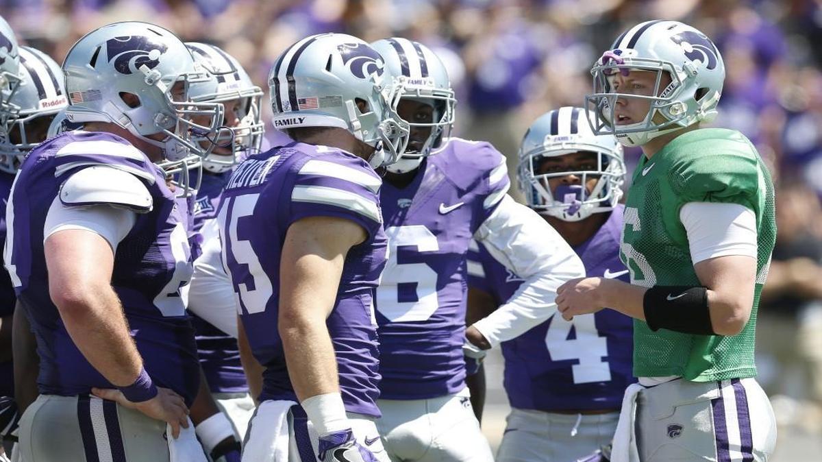 K-State quarterback Jesse Ertz, right, huddles the offense during the Wildcats' annual spring game in April.