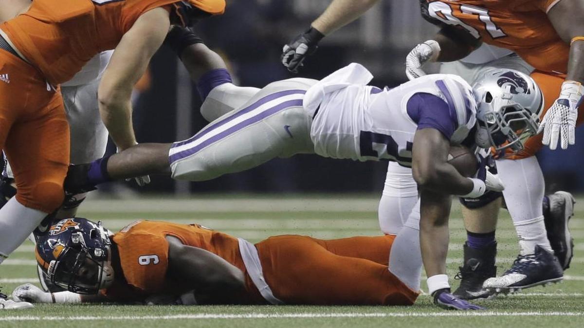 
Kansas State’s Charles Jones dived over Texas-San Antonio’s Marcos Curry during the first half of Saturday’s game.
