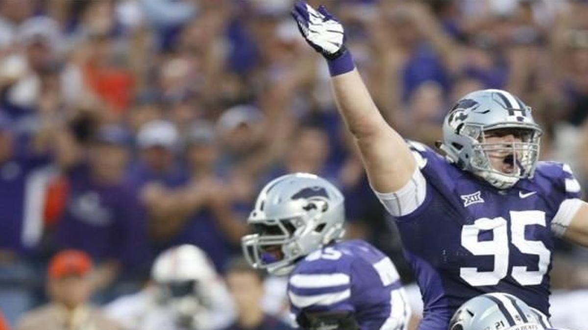 
K-State defensive lineman Travis Britz (center) pointed that it was a K-State recovery in last season’s game against Auburn.
