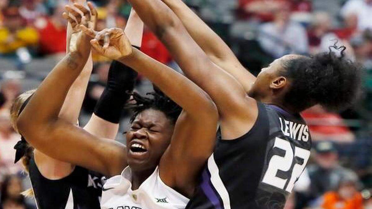 
Baylor forward Sune Agbuke (22) battled Kansas State guard Shaelyn Martin (left) and forward Breanna Lewis (right) for space during the first half Saturday in the quarterfinals of the Big 12 Conference tournament in Dallas. 
