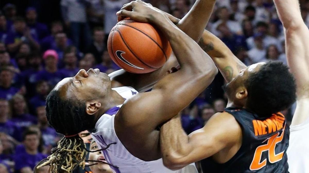 Oklahoma State guard Jeff Newberry (22) and D.J. Johnson of Kansas State battled for a rebound under the Oklahoma State basket as the Wildcats played the Cowboys on Saturday in Manhattan, Kan.