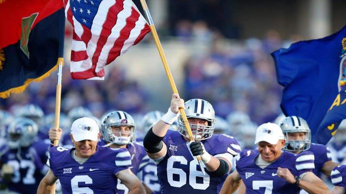 
Center B.J. Finney (66) leads the Wildcats onto the field against Texas Tech in October.

