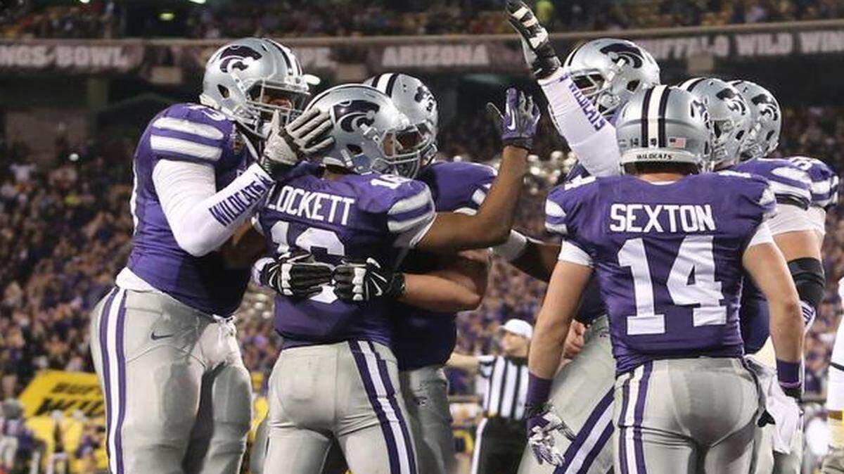 
Kansas State wide receiver Tyler Lockett celebrated with his teammates after scoring his third touchdown of the night against Michigan in the Buffalo Wild Wings Bowl last Dec. 28.
