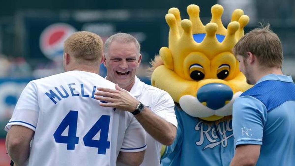 
Kansas State women’s basketball coach Jeff Mittie hugged Kansas State defensive end Ryan Mueller after taking part in a first-pitch ceremony before Sunday’s baseball game between the Kansas City Royals and Los Angeles Angels on June 29, 2014, at Kauffman Stadium in Kansas City, Mo.
