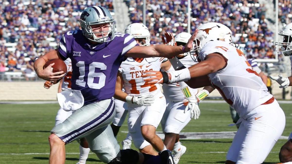 K-State quarterback Jesse Ertz pushes aside Texas safety Jason Hall as he runs for his 2nd touchdown Saturday in Manhattan. (October 22, 2016)