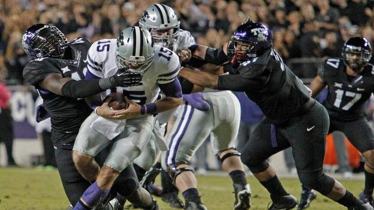 
Kansas State quarterback Jake Waters was wrapped up by Texas Christian defensive end James McFarland in the first quarter of Saturday’s game.


