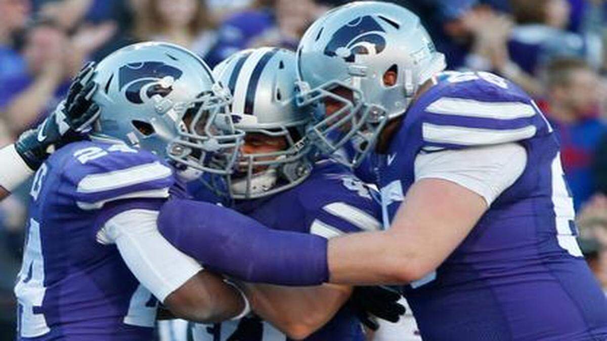 
K-State players celebrate with running back Charles Jones after he scored a second-quarter touchdown on a 11-yard run against Kansas. (Nov. 29, 2014)
