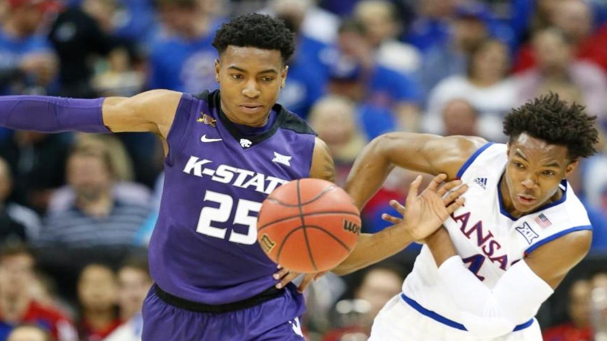 K-State forward Wesley Iwundu and Kansas guard Devonte’ Graham chase after a ball during last March’s Big 12 Tournament at the Sprint Center.