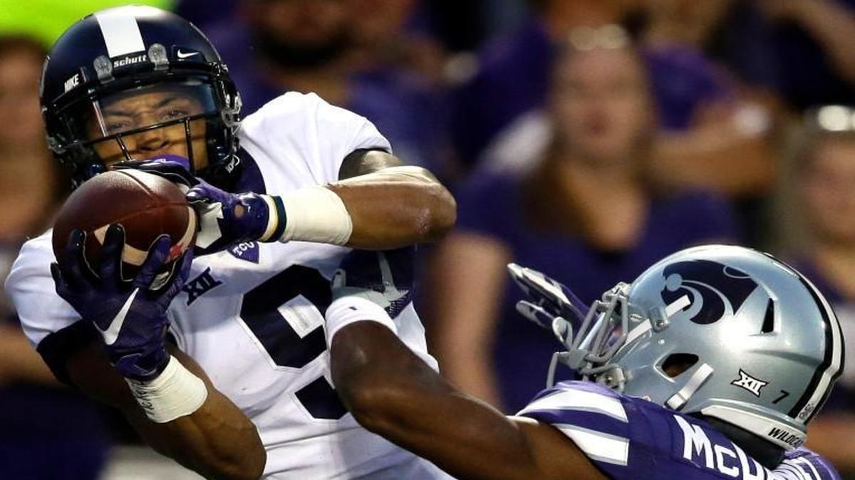 
TCU wide receiver Josh Doctson (9) caught a touchdown pass while covered by Kansas State defensive back Danzel McDaniel (7) in the first half Saturday night in Manhattan, Kan.
