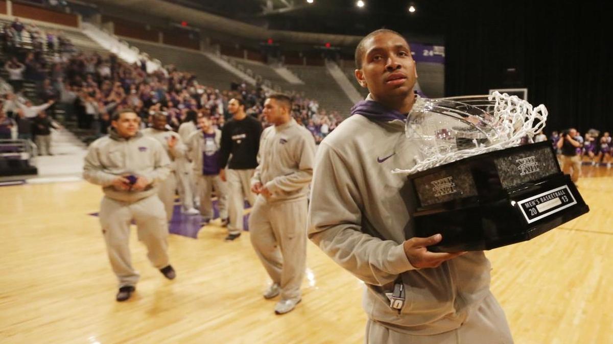 Kansas State guard Rodney McGruder held the Big 12 trophy during a ceremony in 2013.